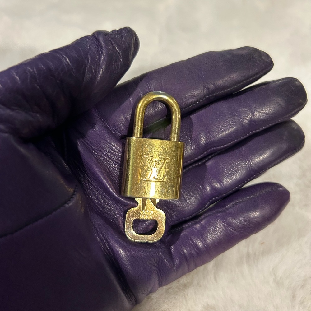 Louis Vuitton #322 Lock & Key Gold Tone in shiny excellent condition.
